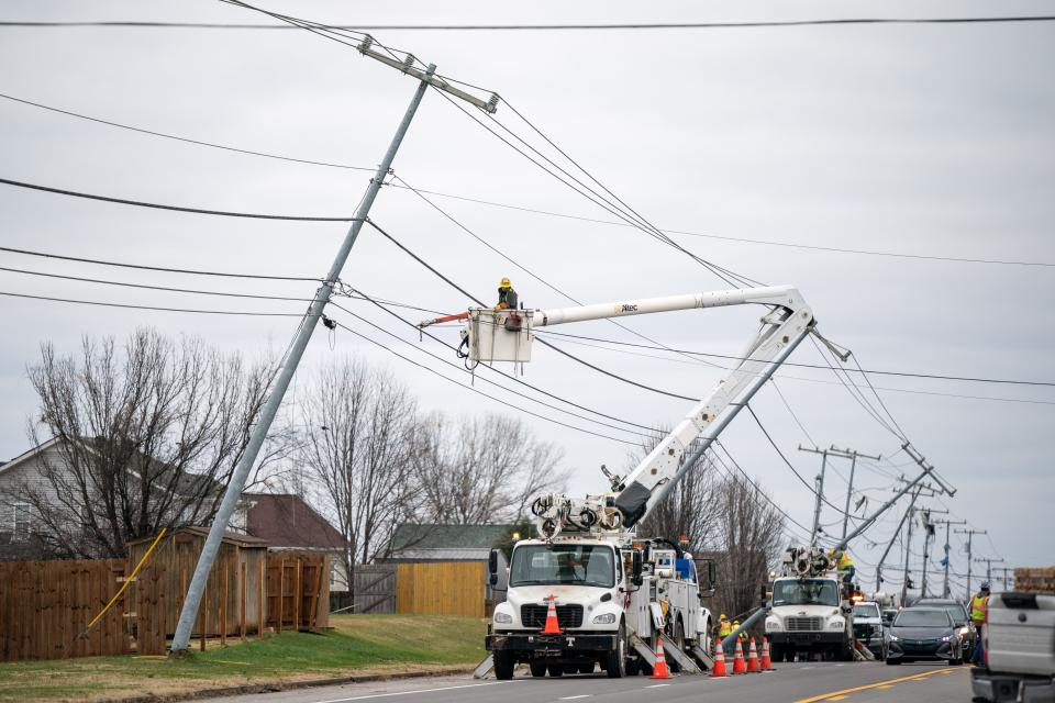 Crews work on repairing utility lines on Tiny Town Rd in Clarksville, Tenn., Sunday, Dec. 10, 2023. Tornadoes struck Middle Tennessee on Saturday, killing at least six people and leaving more than 160,000 Middle Tennessee residents without power.