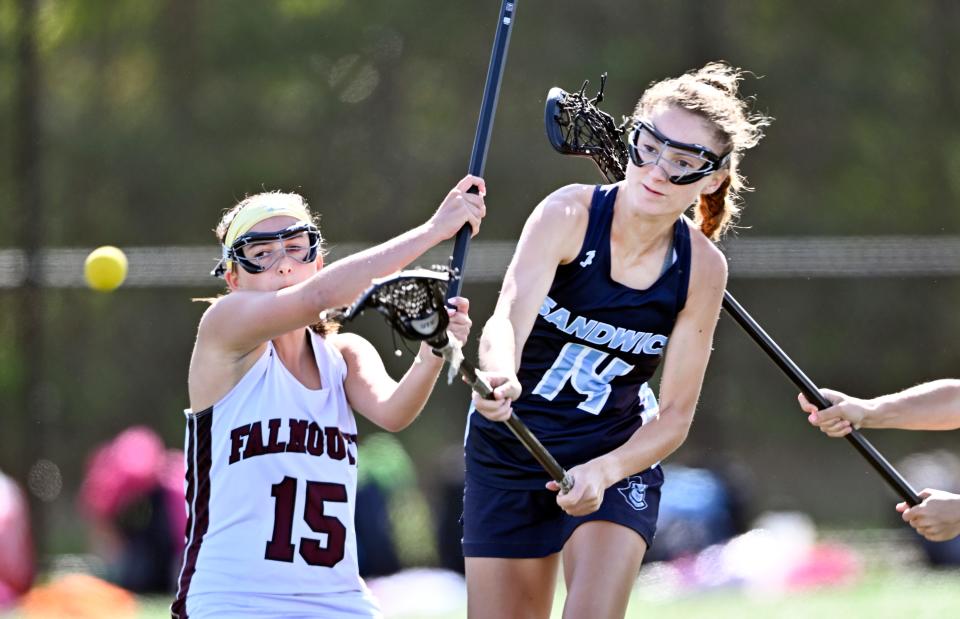 Ryann Cobban of Sandwich fires in a goal past Catelyn Charette of Falmouth for the first goal in an 11-6 win for Sandwich in Falmouth Tuesday. View more photos of the game at: https://www.capecodtimes.com/news/photo-galleries/