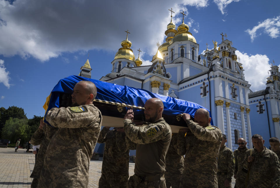 Ukrainian soldiers carry the coffin of a soldier, codename Fanat, killed by the Russian troops in a battle, during his funeral at St Michael cathedral in Kyiv, Ukraine, Ukraine, Monday, July 18, 2022. (AP Photo/Efrem Lukatsky)