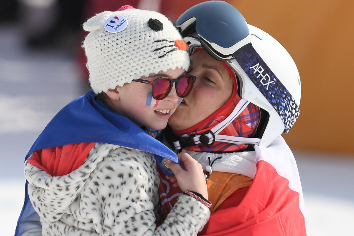 France's Marie Martinod celebrates with her daughter after the women's ski halfpipe final. (Photo: Loic Venance/AFP/Getty Images)