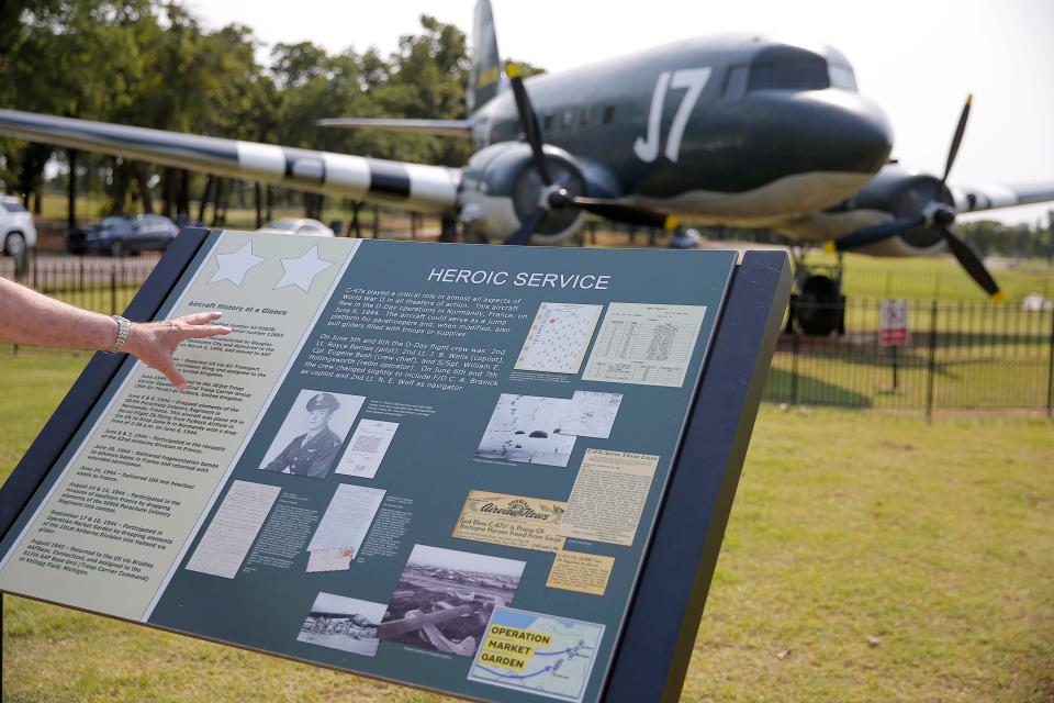 Gary Banz points at a informational display in front of a C-47 at Joe B. Barnes Regional Park in Midwest City, Okla., Saturday, May 28, 2022. Banz wrote and produced a documentary about the C-47 that was built at Tinker Air Force Base, used on D-Day, then restored before being put on display at Joe B. Barnes Regional Park in Midwest City.
