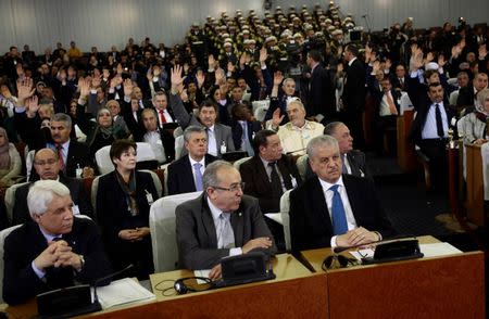 Prime Minister Abdelmalek Sellal (front row, R) looks on as lawmakers raise their hands to vote for the constitutional reforms in Algiers , Algeria February 7, 2016. REUTERS/Ramzi Boudina