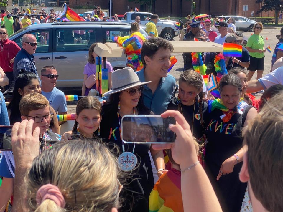 Trudeau poses with Jenene Wooldridge, left, Julie Pellessier-Lush and other members of the Mi'kmaw community at the Pride parade.