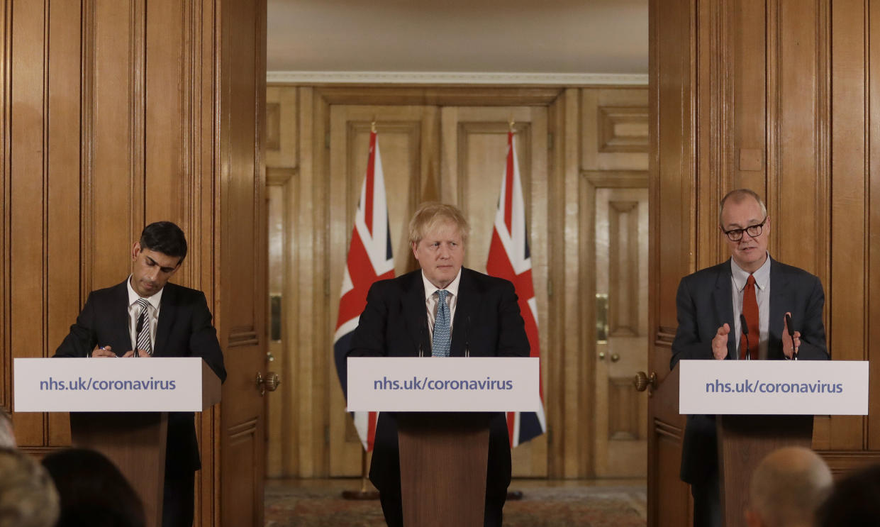 Britain's Chancellor Rishi Sunak, British Prime Minister Boris Johnson and Chief scientific officer Patrick Vallance give a press briefing about the ongoing situation with the COVID-19 coronavirus outbreak, inside 10 Downing Street in London, Tuesday, March 17, 2020. For most people, the new coronavirus causes only mild or moderate symptoms, such as fever and cough. For some, especially older adults and people with existing health problems, it can cause more severe illness, including pneumonia. (AP Photo/Matt Dunham, Pool)