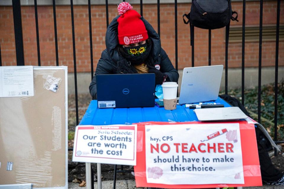Melissa Vozar, a teacher at Suder Elementary School teacher in Chicago, sits outside to teach a virtual class on Jan. 11, 2021.