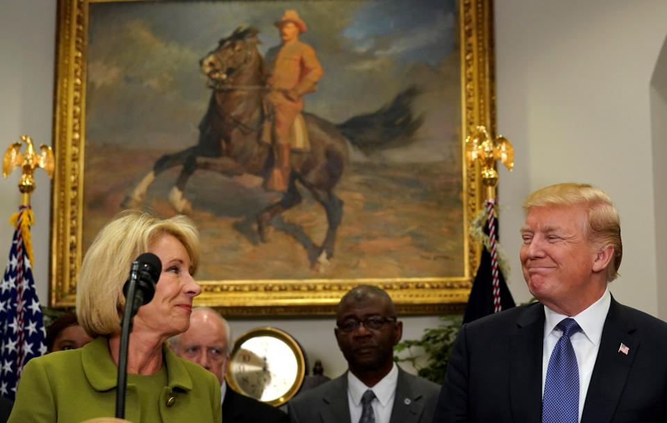U.S. President Donald Trump looks toward Secretary of Education Betsy DeVos before he announced a Historically Black Colleges and Universities (HBCUs) initiative at the White House in Washington, U.S., February 27, 2018. REUTERS/Kevin Lamarque