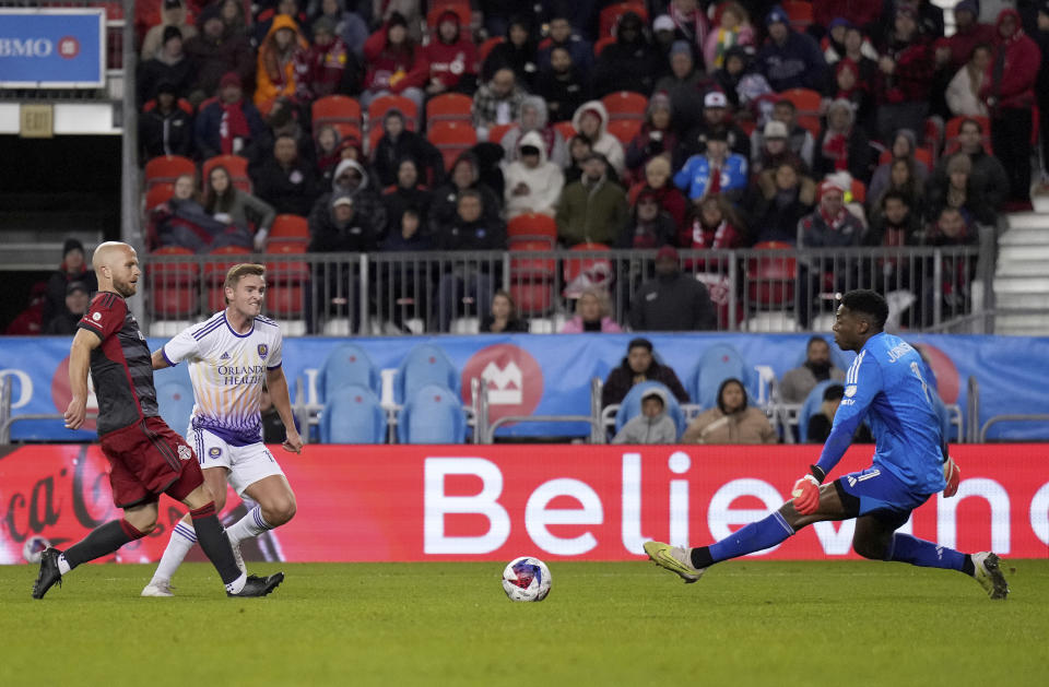 Toronto FC midfielder Michael Bradley, left, looks on as Orlando City forward Duncan McGuire, second from left, scores on Toronto keeper Sean Johnson (1) during the second half of an MLS soccer match in Toronto on Saturday, Oct. 21, 2023. (Nathan Denette/The Canadian Press via AP)
