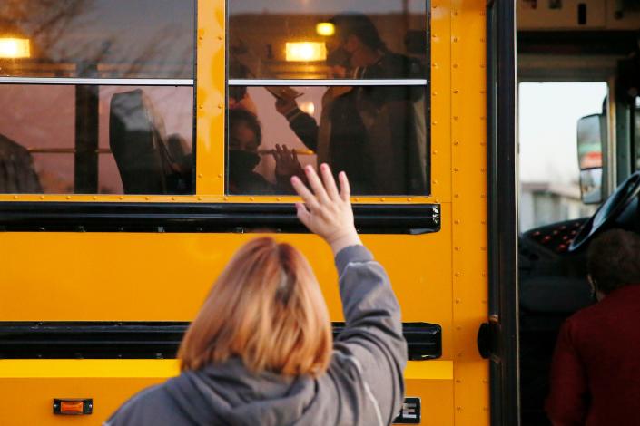 El Paso resident Gabi Ponce waves goodbye to her daughter Lucero Carrillo-Ponce at a bus stop in El Paso in February.