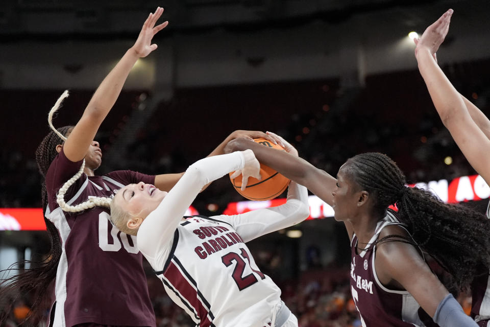 South Carolina forward Chloe Kitts vies for the ball with Texas A&M guard Sydney Bowles, left, and guard Aicha Coulibaly during the second half of an NCAA college basketball game at the Southeastern Conference women's tournament Friday, March 8, 2024, in Greenville, S.C. (AP Photo/Chris Carlson)