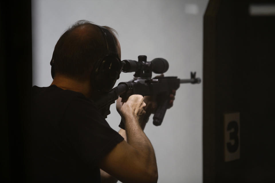 AURORA, CO - JULY 22: A member of Firing-Line prepares fires his weapon at the gun range July 22, 2012 in Aurora, Colorado. Firing-Line is located not far from where suspect gunman James Eagan Holmes, 24, is accused of killing 12 people at a screening of the new "Batman" film last Friday. (Photo by Joshua Lott/Getty Images)