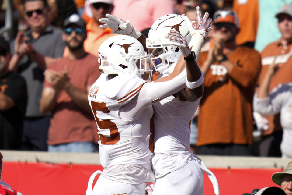 Texas wide receiver Adonai Mitchell, right, celebrates after his touchdown with Gunnar Helm, left, during the first half of an NCAA college football game against Houston, Saturday, Oct. 21, 2023, in Houston. (AP Photo/Eric Christian Smith)