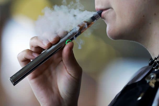 PHOTO: A woman uses an electronic cigarette in Mayfield Heights, Ohio, Oct. 4, 2019. (Tony Dejak/AP, FILE)