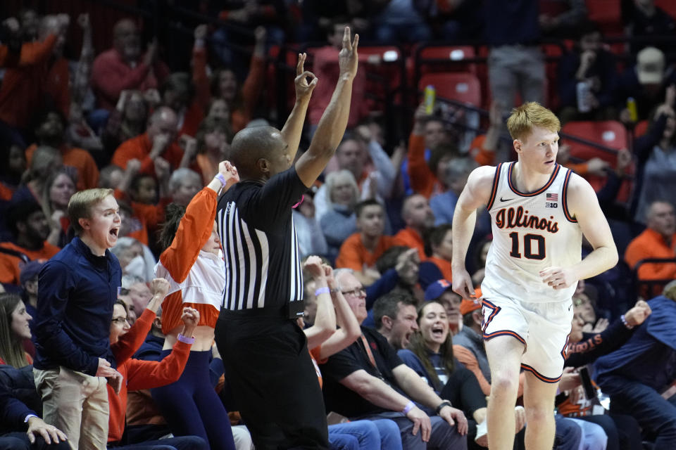 People react after a 3-point basket by Illinois' Luke Goode, right, during the second half of an NCAA college basketball game, Saturday, Jan. 27, 2024, in Champaign, Ill. Illinois won 70-62. (AP Photo/Charles Rex Arbogast)