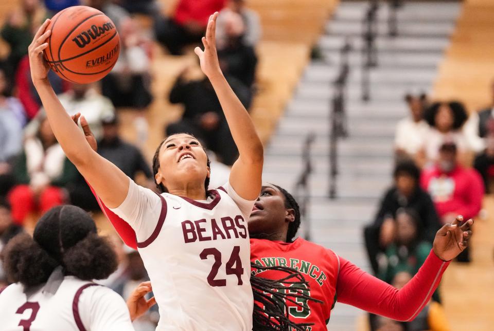 Lawrence Central Bears forward Aniyah Mckenzie (24) reaches for the ball Thursday, Dec. 7, 2023, during the game at Lawrence Central High School in Indianapolis. The Lawrence Central Bears defeated the Lawrence North Wildcats, 57-55.