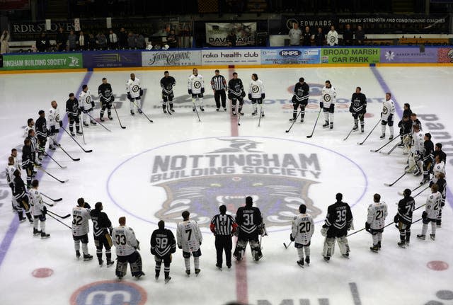 Players observe a tribute to Nottingham Panthers’ Adam Johnson