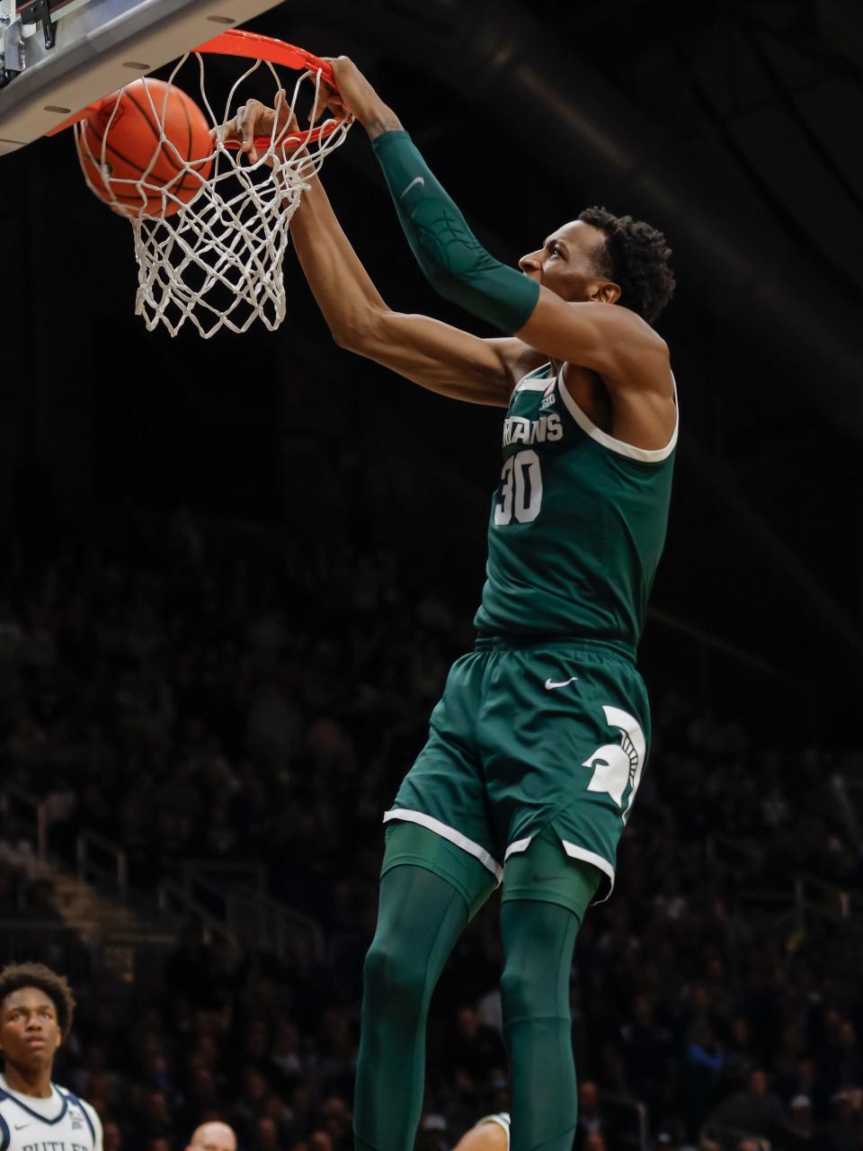Michigan State center Marcus Bingham Jr. dunks the ball during the first half in Indianapolis, Wednesday, Nov. 17, 2021.