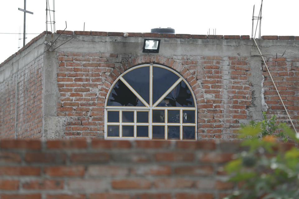 A window is broken at the drug rehabilitation center that was attacked in Irapuato, Mexico, Thursday, July 2, 2020. Gunmen burst into the center and opened fire Wednesday, killing 24 people and wounding seven, authorities said. (AP Photo/Eduardo Verdugo)