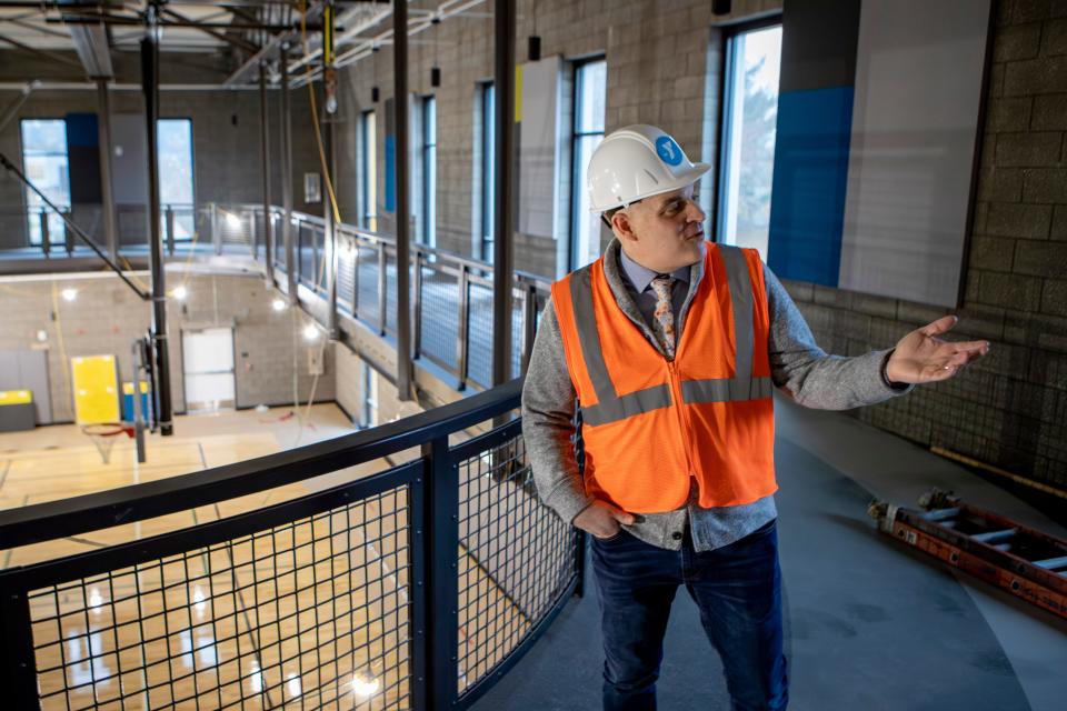 Eugene Family YMCA chief executive officer Brian Steffen walks the track over the gym in the new YMCA building.