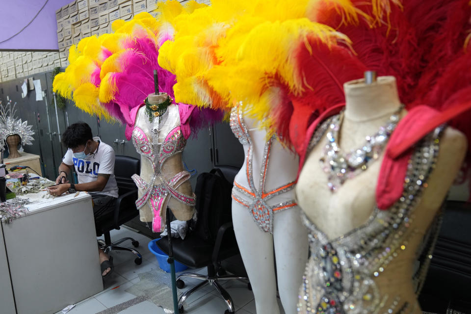 Workers prepare costumes for the Phuket Simon Cabaret in Phuket, southern Thailand, Tuesday, June 29, 2021. Thailand's government will begin the Phuket Sandbox scheme to bring the tourists back to Phuket starting July 1. The cabaret would not open immediately but its dancers might start with smaller shows in hotels and restaurants until larger number of tourists start to arrive. (AP Photo/Sakchai Lalit)