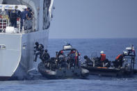 Armed Philippine Coast Guard personnel board the PCG Melchora Aquino ship during a Coast Guard drill off the waters of Bataan, Philippines., Tuesday, June 6, 2023. Philippines, U.S. and Japanese coast guard participated in exercises which involved drills on maritime law enforcement and security.(AP Photo/Aaron Favila)