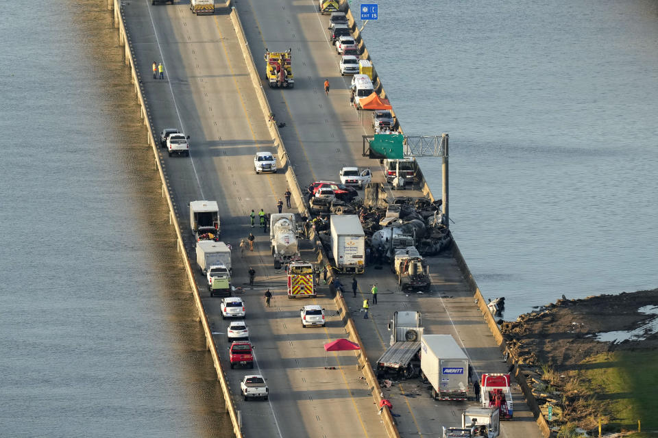 In this aerial photo, responders are seen near wreckage in the aftermath of a multi-vehicle pileup on I-55 in Manchac, La., Monday, Oct. 23, 2023. A “superfog” of smoke from south Louisiana marsh fires and dense morning fog caused multiple traffic crashes involving scores of cars. (AP Photo/Gerald Herbert)