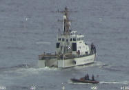 Coast Guard Cutter Ibis' crew searching for people missing from a capsized boat off the coast of Florida, Tuesday, Jan. 25, 2022. The Coast Guard searched through the night Wednesday for 39 people missing from a capsized boat after a solitary survivor was found clinging to the overturned hull. Crews on at least four ships and five aircraft already scanned a vast area about the size of Rhode Island on Tuesday after the man was pulled to safety. (U.S. Coast Guard via AP)