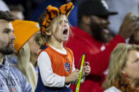A fan cheers for Auburn during the second half of an NCAA college football game between Auburn and Alabama, Saturday, Nov. 27, 2021, in Auburn, Ala. (AP Photo/Vasha Hunt)