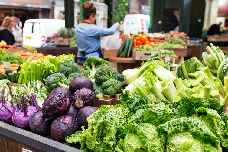 Fresh vegetables in crates at a farmers market, London, UK