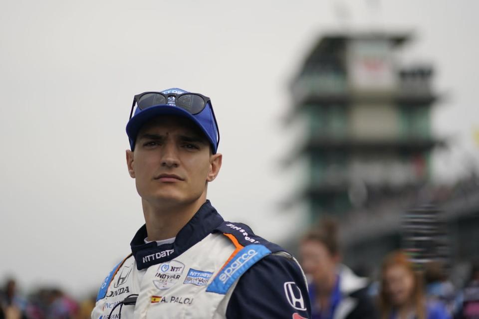 Defending IndyCar Series champion Alex Palou looks toward the track during practice.