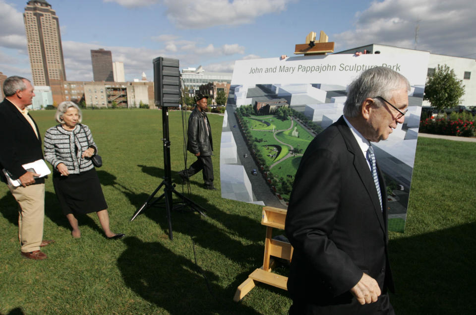 John Pappajohn walks to the podium followed by his wife Mary during a groundbreaking ceremony for the John and Mary Pappajohn Sculpture Park in downtown Des Moines.