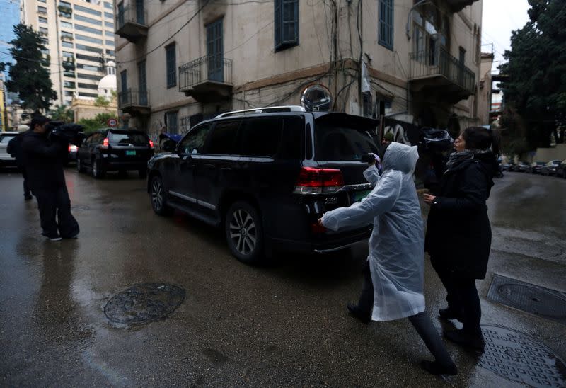 Journalists follow a car outside the house believed to belong to former Nissan chairman Carlos Ghosn in Beirut