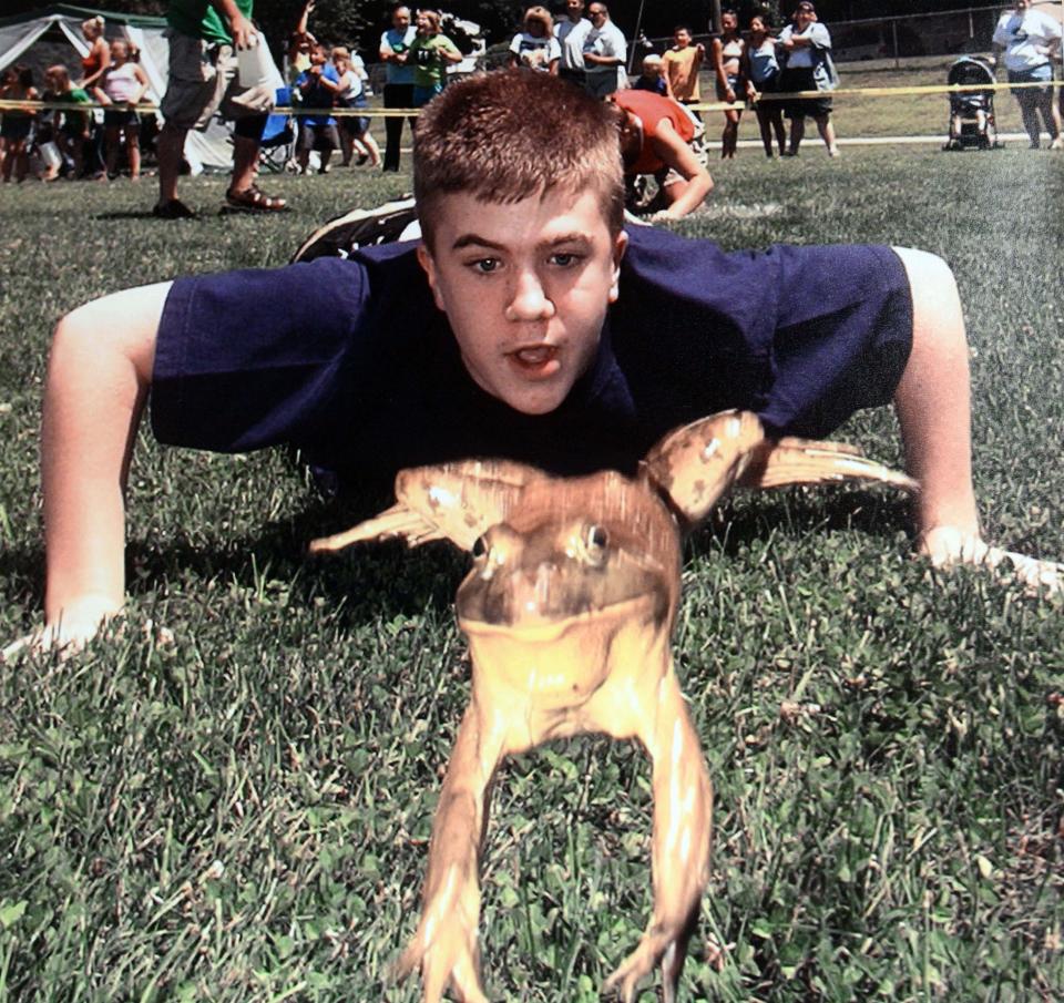  Colin Montigny, 12, coaxes his frog named "Bob" to a first place finish in the 12 to 17 age group in the 4th annual Frog Jumping Contest in Plainfield July 20, 2003. 