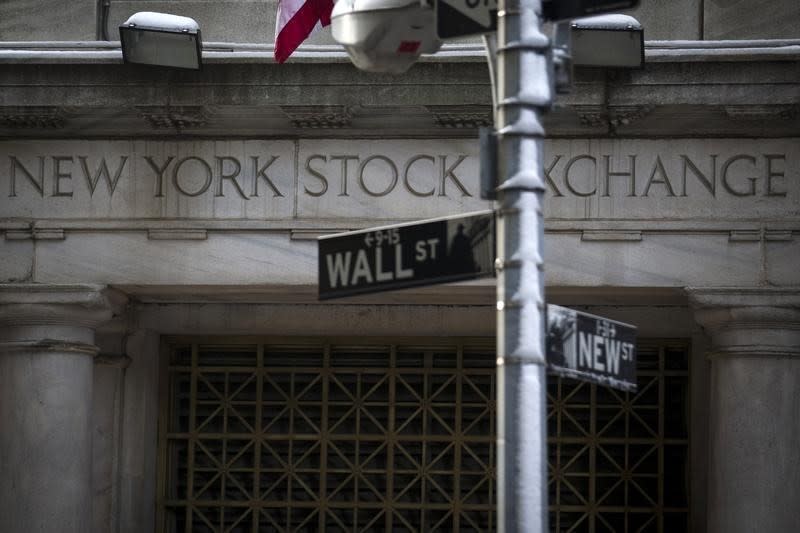 The Wall St. sign is seen outside the door to the New York Stock Exchange in New York's financial district February 4, 2014. REUTERS/Brendan McDermid
