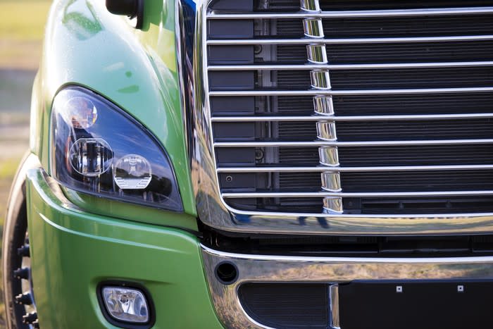 Detail of a grille and headlamp in a modern heavy duty semi truck.