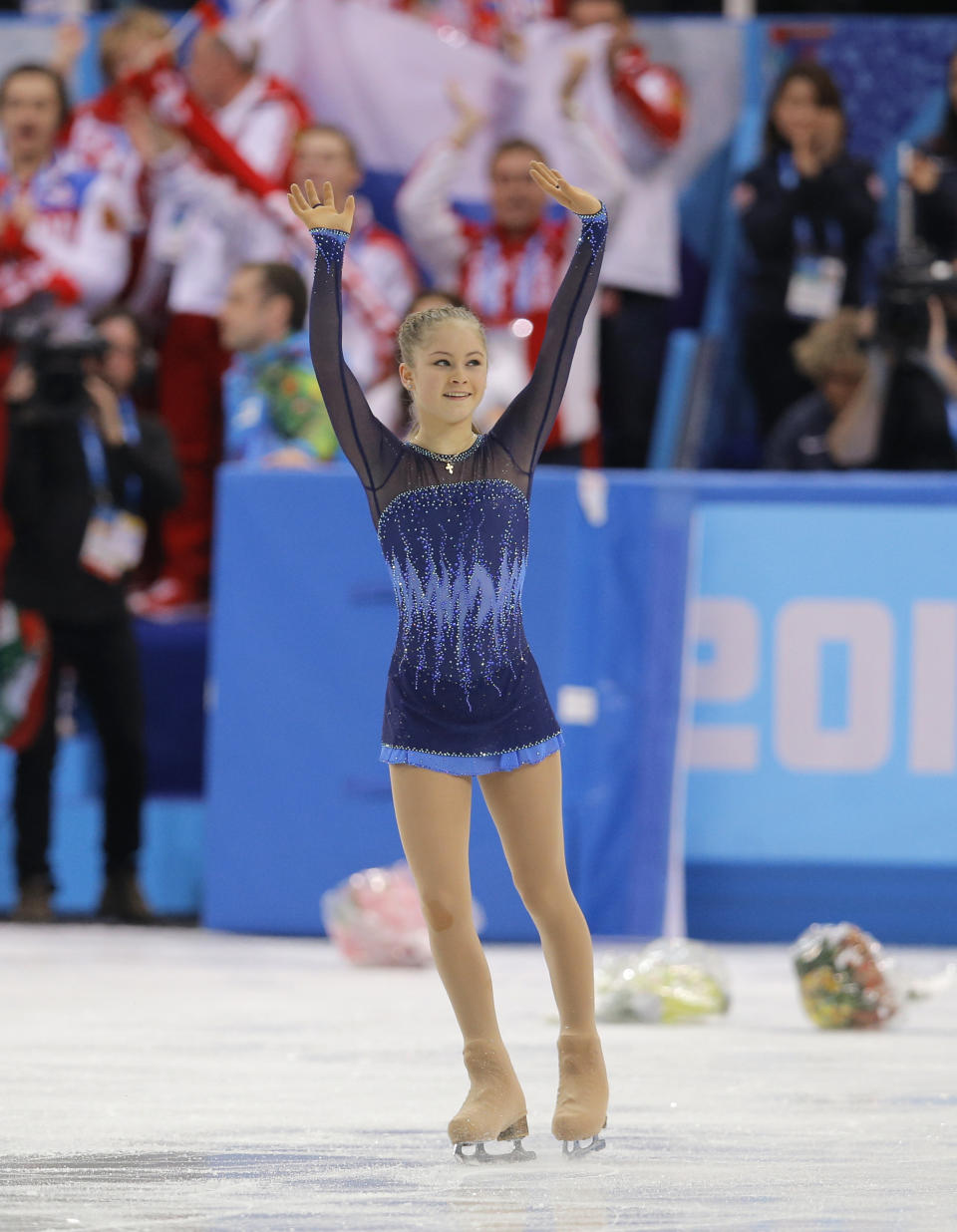 Yulia Lipnitskaya of Russia waves to spectators after competing in the women's team short program figure skating competition at the Iceberg Skating Palace during the 2014 Winter Olympics, Saturday, Feb. 8, 2014, in Sochi, Russia. (AP Photo/Vadim Ghirda)