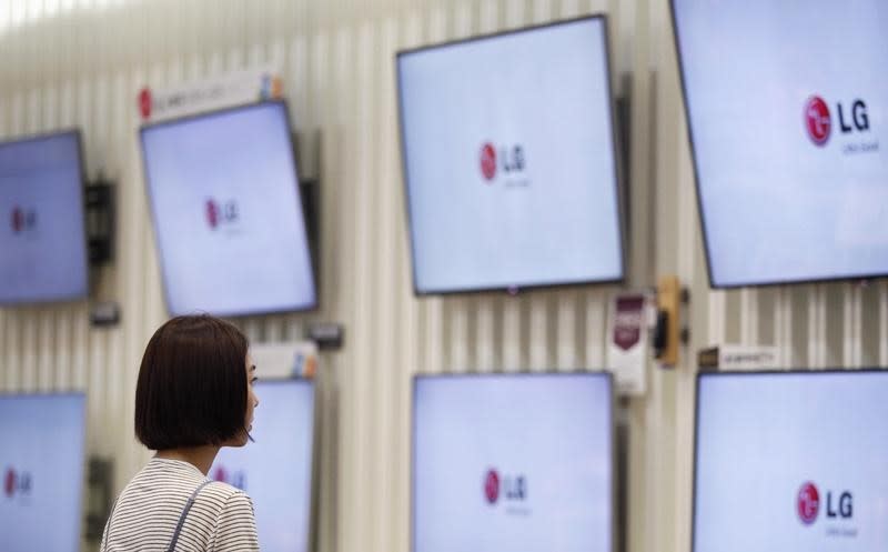 A customer looks at LG Electronics' television sets, which are made with LG Display flat screens, at its store in Seoul July 22, 2014. REUTERS/Kim Hong-Ji