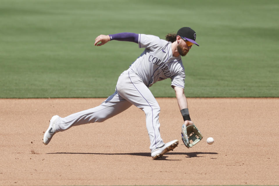 Colorado Rockies second baseman Brendan Rodgers runs down a ground ball hit by San Diego Padres' Nomar Mazara during the fifth inning of a baseball game Sunday, June 12, 2022, in San Diego. (AP Photo/Mike McGinnis)