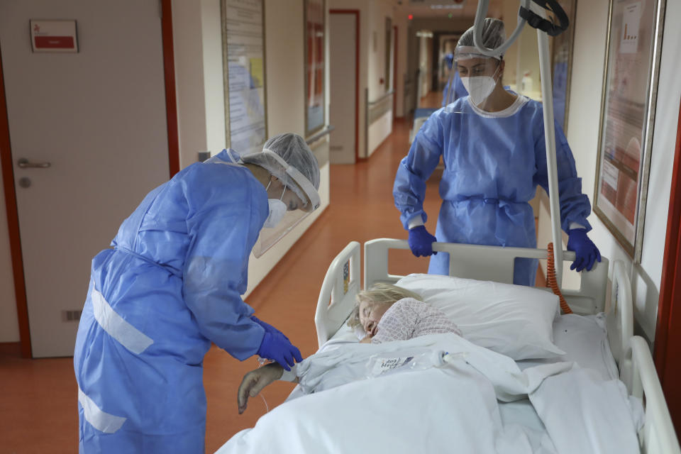 FILE - Medical staff attend to a patient in the COVID-19 section of the University Clinical Centre hospital in Banja Luka, Bosnia, on Nov. 4, 2021. The World Health Organization said Friday May 5, 2023 that COVID-19 no longer qualifies as a global emergency, marking a symbolic end to the devastating coronavirus pandemic that triggered once-unthinkable lockdowns, upended economies and killed millions of people worldwide. (AP Photo, File)