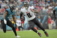 Atlanta Falcons tight end Kyle Pitts (8) runs past Jacksonville Jaguars safety Rudy Ford (5) after a reception during the second half of an NFL football game, Sunday, Nov. 28, 2021, in Jacksonville, Fla. (AP Photo/Phelan M. Ebenhack)