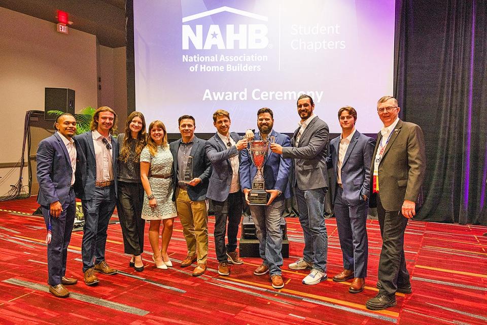 From left, project teammates Vidal Polk, John Crow, Allison Lampley, Annalise Phillips, Robert Deetjen, Alex Becker, Ronnie Merrill, John Timm, Brian Pierce and associate professor and mentor Duane Vanhook celebrate Middle Tennessee State University capturing the National Association of Home Builders Student Chapters first-place award at the Las Vegas, Nev., Convention Center earlier this year.