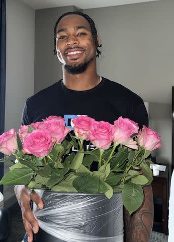 <p>Simone Biles/Instagram</p> Jonathan Owens holds a pot full of flowers