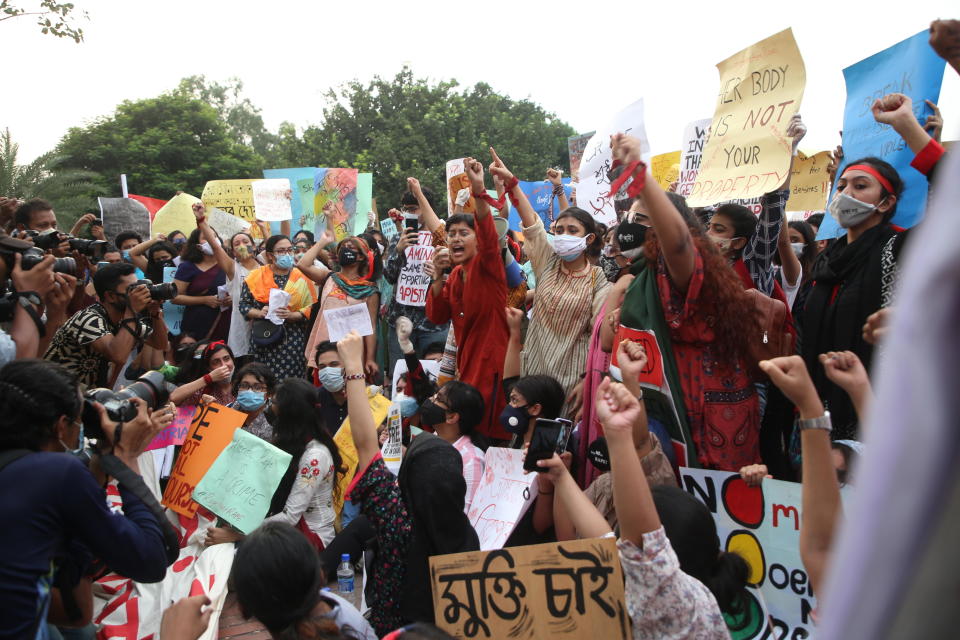 Women's rights activist Umama Zillur (center, in red shirt) leads a protest chant during a demonstration outside Bangladesh's parliament in Dhaka, October 10, 2020, calling on the government to address sexual violence in the country.  / Credit: MD Muntasir