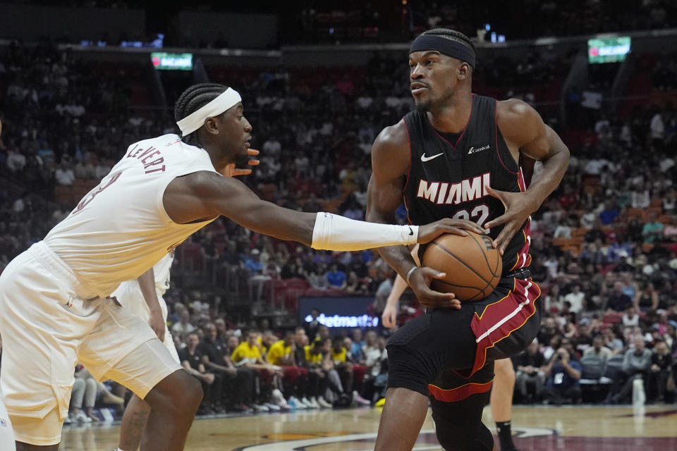 Miami Heat forward Jimmy Butler (22) drives to the basket as Cleveland Cavaliers guard Caris LeVert (3) defends during the second half of an NBA basketball game, Sunday, March 24, 2024, in Miami. (AP Photo/Marta Lavandier)