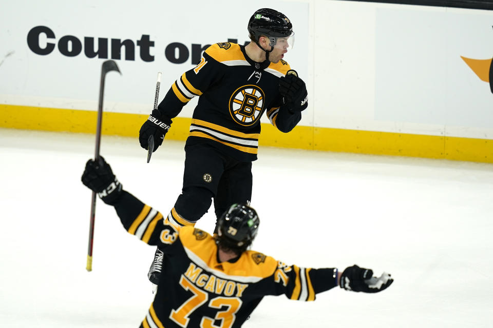 Boston Bruins left wing Taylor Hall (above) celebrates his winning goal with defenseman Charlie McAvoy (73) in the overtime period of an NHL hockey game against the New York Islanders, Monday, May 10, 2021, in Boston. (AP Photo/Elise Amendola)