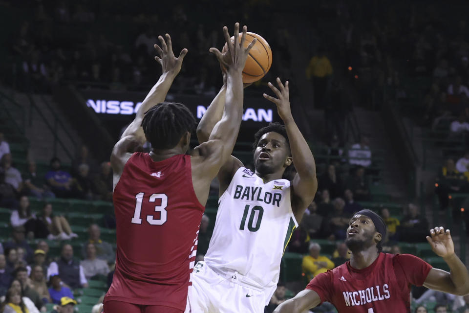 Baylor guard Adam Flagler (10) shoots over Nicholls State forward Mekhi Collins (13) during the first half of an NCAA college basketball game Wednesday, Dec. 28, 2022, in Waco, Texas. (AP Photo/Jerry Larson)