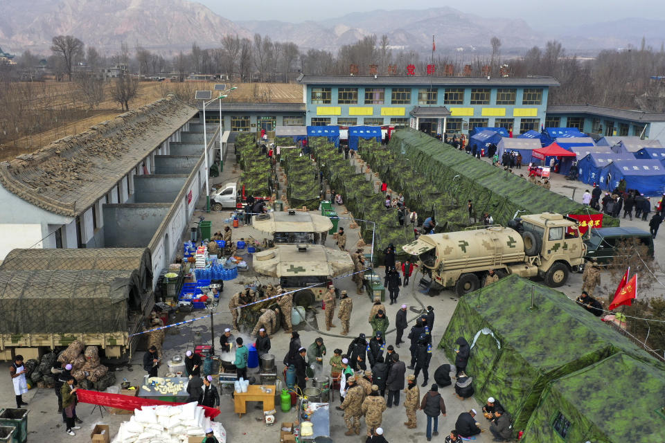 Volunteers preparing foods to quake victims at a temporary settlement in Chenjiacun village in Jishishan county in northwest China's Gansu province on Wednesday, Dec. 20, 2023. Hundreds of temporary housing units were being set up in northwest China on Thursday for survivors of an earthquake, according to state media reports. (ChinatopixvVia AP)