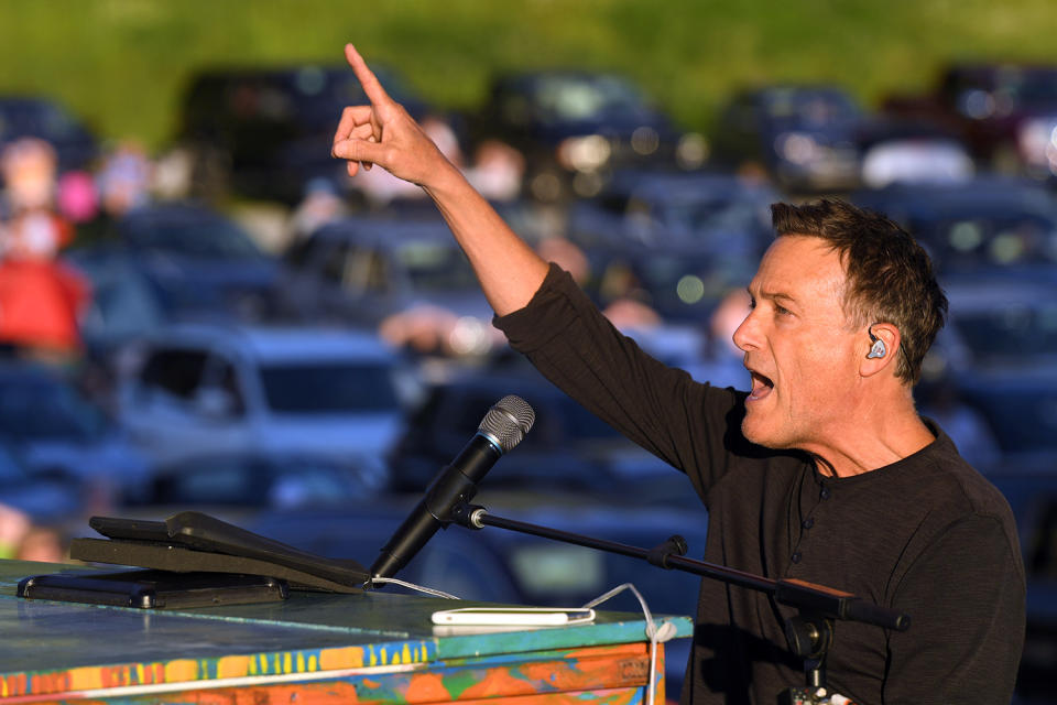 <p>Singer Michael W. Smith takes the mic on Saturday during his drive-in concert in Franklin, Tennessee. </p>