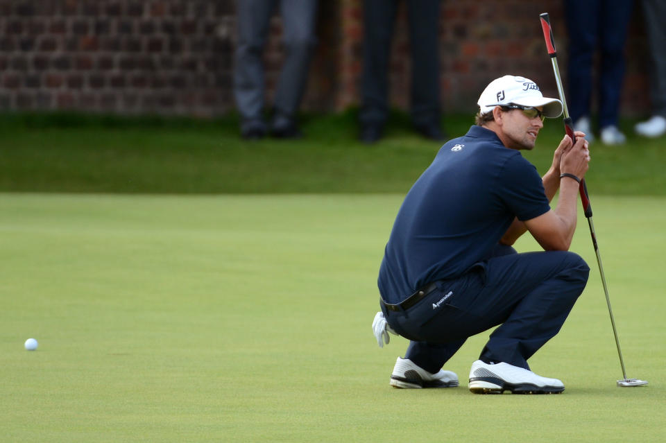 Adam Scott squats down after missing a putt