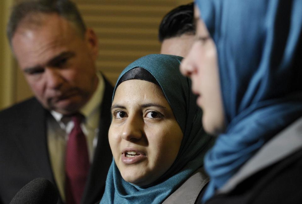 Sen. Tim Kaine, D-Va., chairman of the Senate Foreign Relations subcommittee on Near Eastern, Southern and Central Asian Affairs, listens at left as Heba Sawan, center, speaks at a news conference as her sister Amineh Sawan, right, watches on Capitol Hill in Washington, Thursday, Feb. 6, 2014. The Sawan sisters were survivors of the August 2013 chemical weapons attack in Moadamiya, Syria that left more than 1,200 Syrians dead and many more wounded. (AP Photo/Susan Walsh)