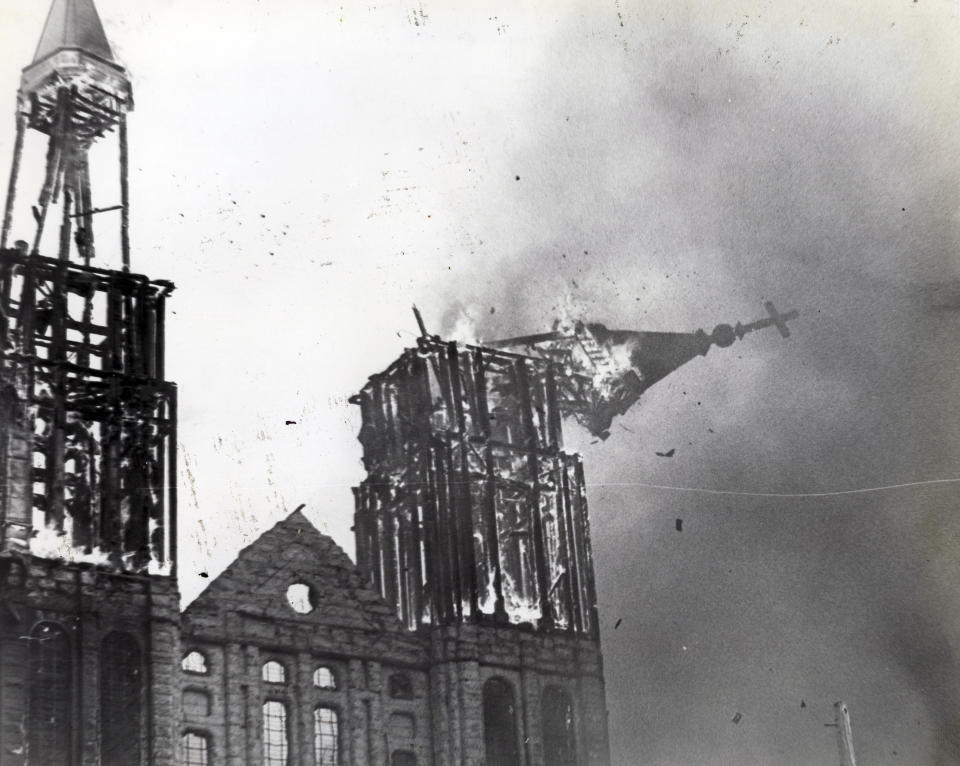 In this May 11,1982 photo, a steeple falls as the Notre Dame de Lourdes Church burns in Fall River, Mass. The cathedral was completed in 1891 and was in the midst of a $1 million renovation when the fire occurred. It was determined that a worker's blowtorch had ignited dry roof timbers. (The Herald News via AP)